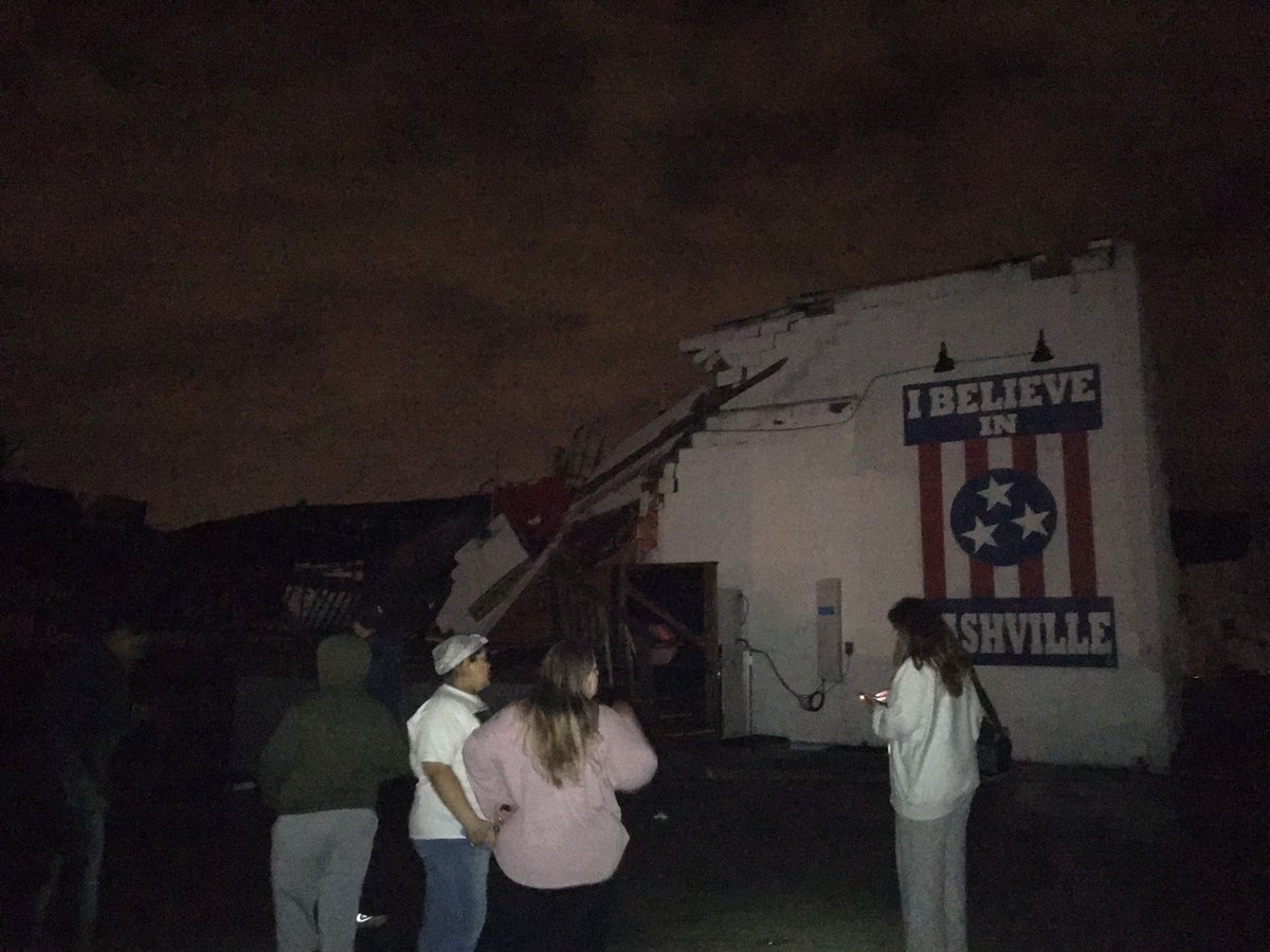 ErikBacharach's tweet photo. Amid the surreal damage/destruction down Main Street and Woodland Street in East Nashville tonight, hard not to be struck by the scene at @BasementEast. Building is almost completely destroyed, but the iconic “I believe in Nashville” mural persists. #nashvilletornado https://t.co/ydLPOcRO3i