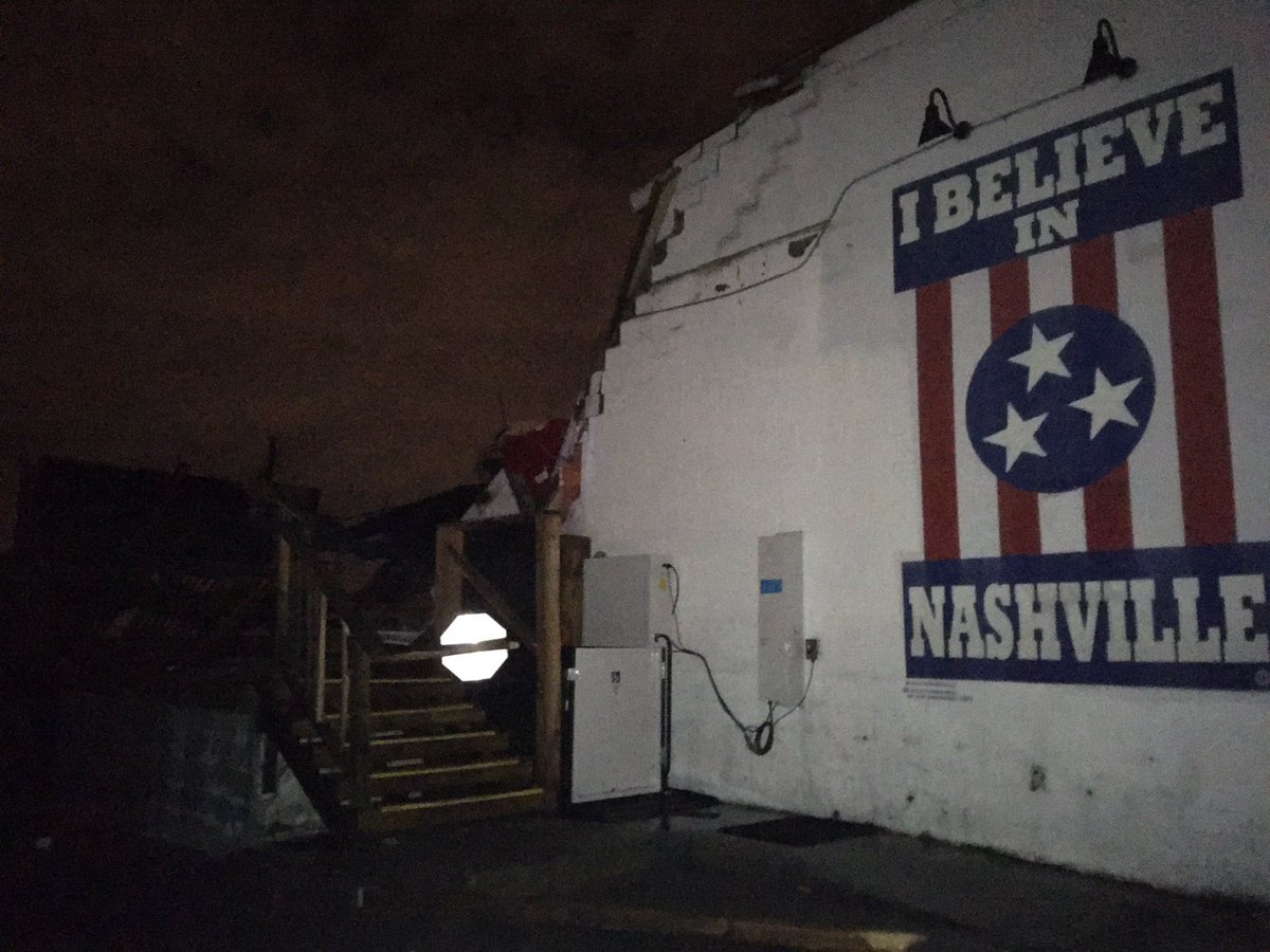 ErikBacharach's tweet photo. Amid the surreal damage/destruction down Main Street and Woodland Street in East Nashville tonight, hard not to be struck by the scene at @BasementEast. Building is almost completely destroyed, but the iconic “I believe in Nashville” mural persists. #nashvilletornado https://t.co/ydLPOcRO3i