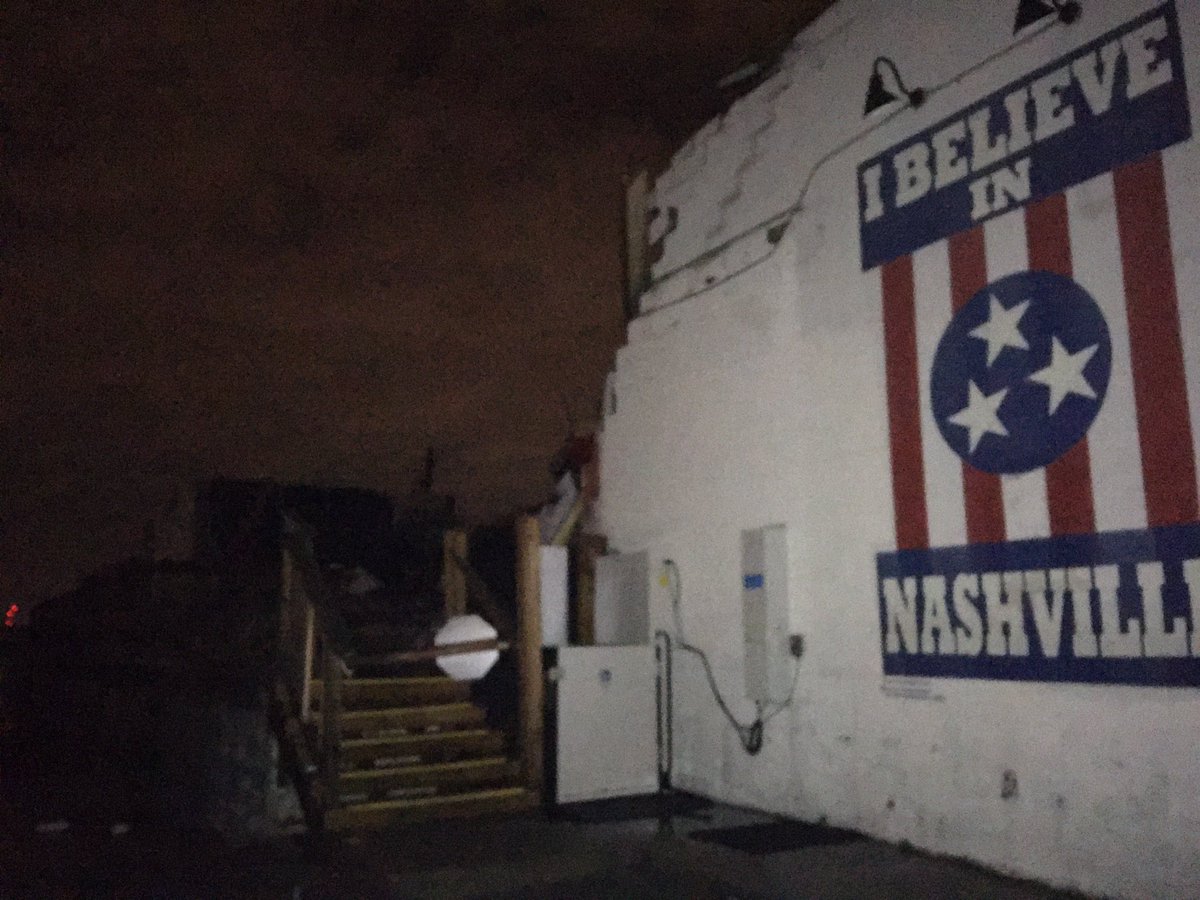 ErikBacharach's tweet photo. Amid the surreal damage/destruction down Main Street and Woodland Street in East Nashville tonight, hard not to be struck by the scene at @BasementEast. Building is almost completely destroyed, but the iconic “I believe in Nashville” mural persists. #nashvilletornado https://t.co/ydLPOcRO3i
