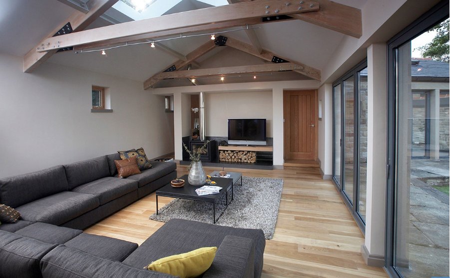 High ceilings, contemporary features and the expanse of bi-folding doors catch your eye in this large family living room, from one of our residential projects. #yorkshirearchitects #interiordesign #livingroominteriors #contemporaryinterior