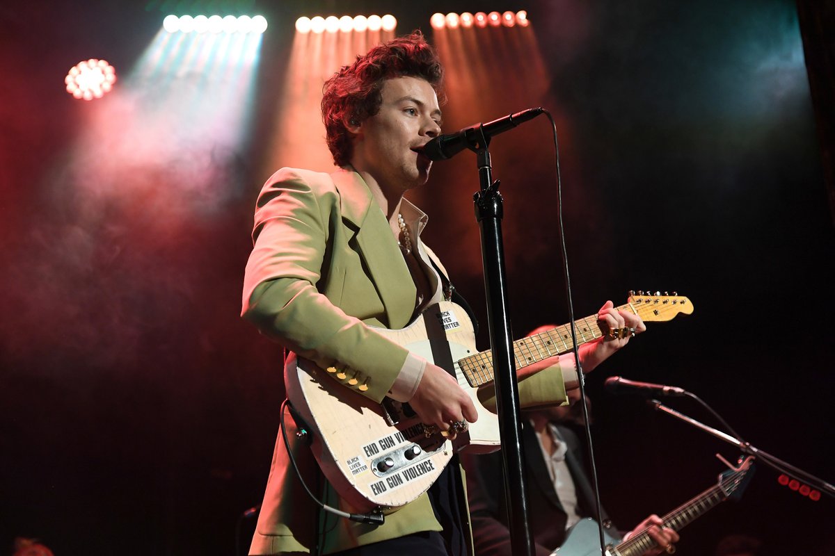gucci's tweet photo. Performing live at @iHeartRadio Secret Session, @Harry_Styles wore a custom #Gucci wool mohair jacket with a silk shirt, canvas trousers and leather boots designed by #AlessandroMichele.  
Photo: Thomas Falcone for iHeartRadio and Kevin Mazur/Getty Images for iHeartRadio https://t.co/RwbnZV6ggD