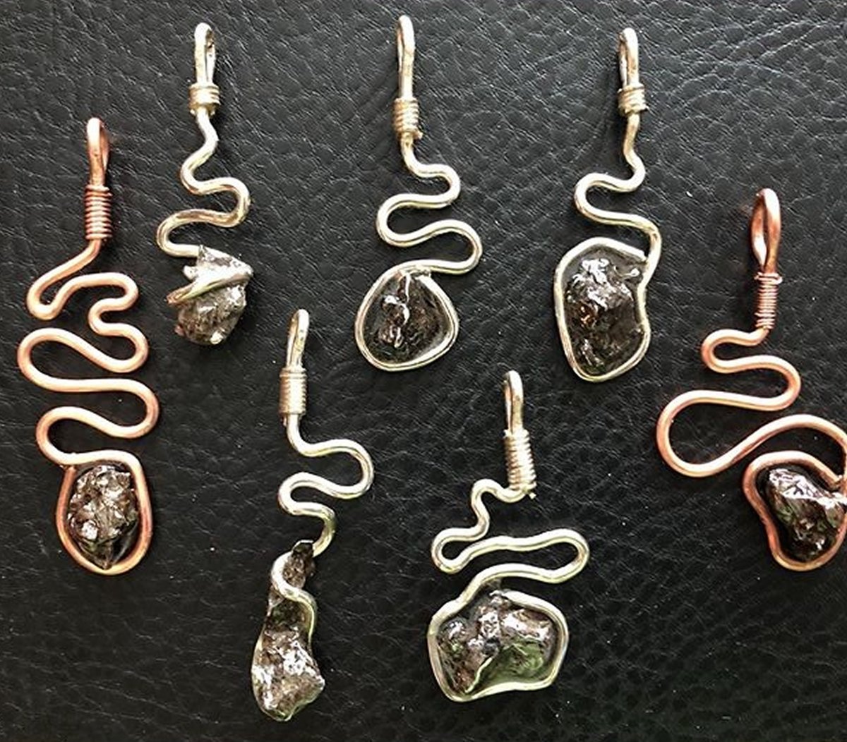 Meteorite coil pendants in sterling silver or copper. Which path represents your life journey. Buy at #lifescoil lifescoil.com. #meteoritejewelry #uniquejewelry #stonejewelry #silverjewelry #copperjewelry #bohostyle #gothgirl #heavymetal
