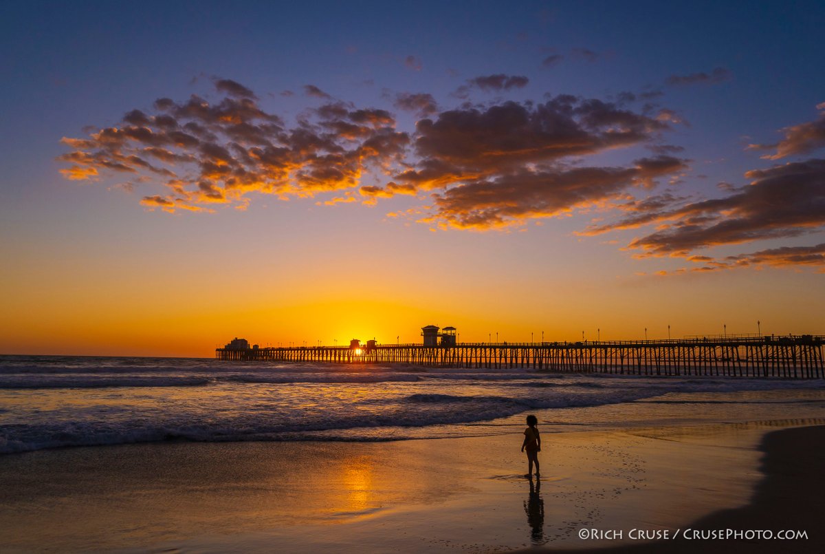 RichOnOWN's tweet photo. A girl watches the #sunset in #Oceanside - March 2, 2020. @VisitOceanside @visitsandiego @VisitCA #VisitSD #StormHour #nikonnofilter #CAwx https://t.co/6iIbcdd09s