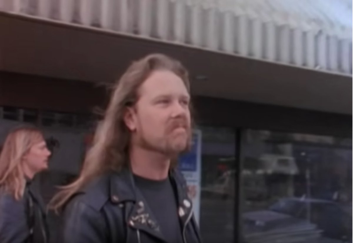 Long haired guy walking outside