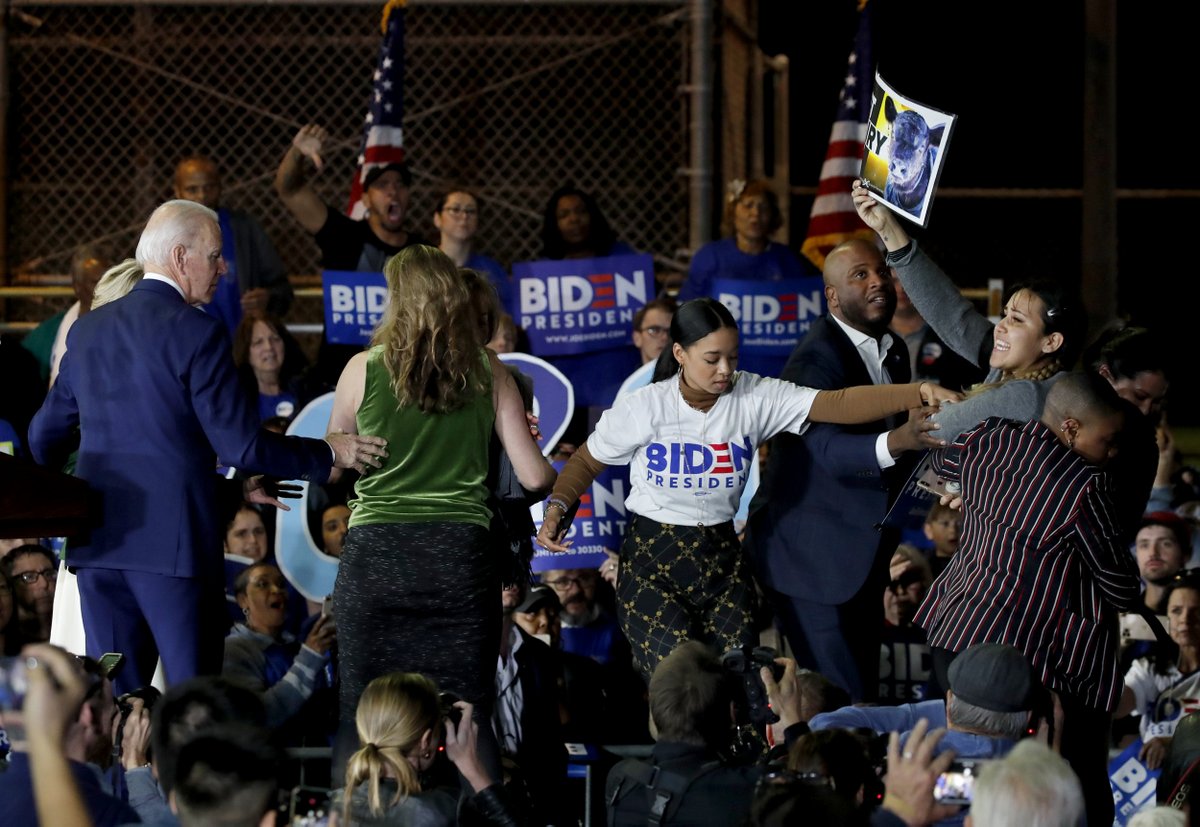 NBCNews's tweet photo. Protesters are escorted out after rushing the stage, disrupting Joe Biden during a #SuperTuesday speech in Los Angeles. 

📷 Mike Blake / @Reuters https://t.co/VsYlDSJ2DN