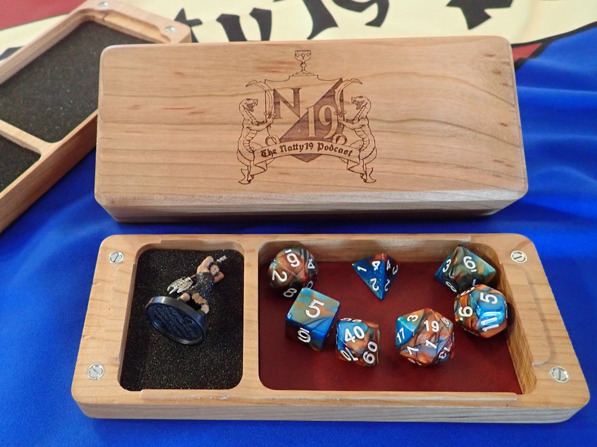 N19podcast's tweet photo. Natty19 is excited to bring you this #ttrpg #giveaway! Follow us and retweet by March 11th for a chancce to win a premium Natty19 Podcast dice box by @Oni_Technology. Bring your #dnd or #pathfinder game to the next level with this high quality "dice char-rier"! https://t.co/dhWpP8y75b