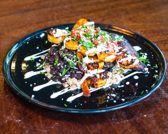 It's a great day to treat yourself to something indulgent. Like the Shrimp Cubanos. Achiote marinated shrimp skewers served with sweet plantains, red rice, black beans, Cotija cheese, pico de gallo and habanero crema. 

Pair that with our $10 off all wine bottles on Wednesdays.