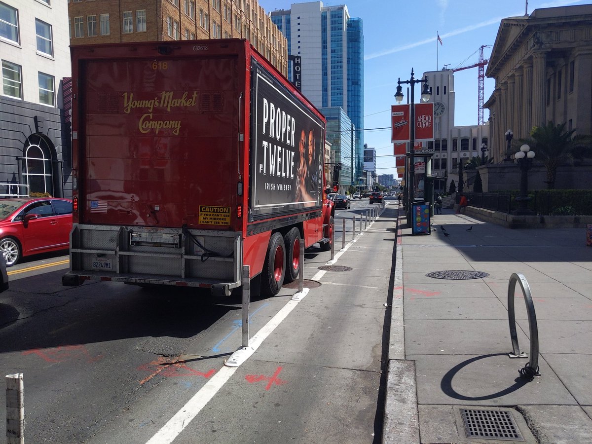 Over to SF. Here's the new 5th St. bike lane, first block in front of the Old Mint: 4'7" wide. So sad for Young's Market that they have to block a car lane now.