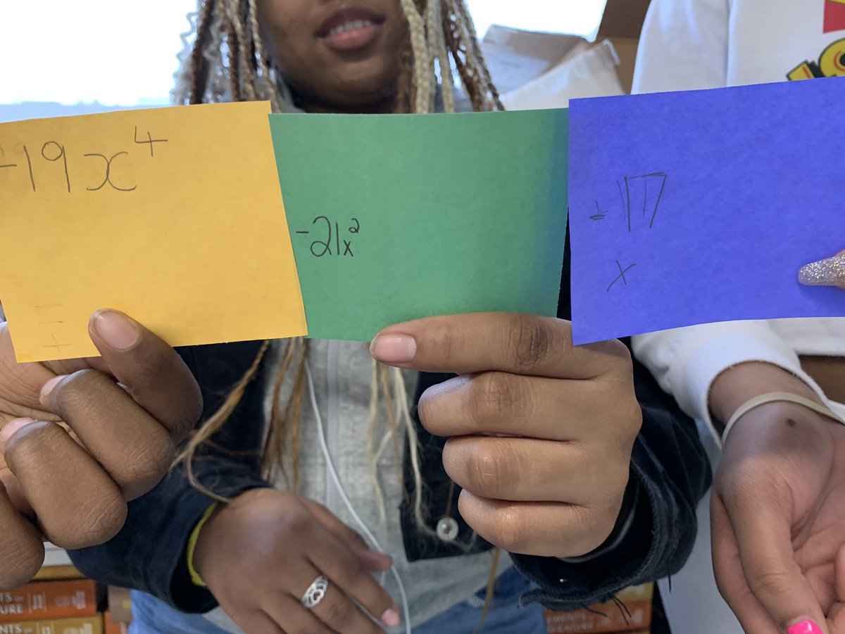 Groups of students representing polynomials in standard form. Helps kids realize that the sign needs to remain with the term! Got ALL students involved too! #algebra1 #kinestheticlearning @The_MVHS @