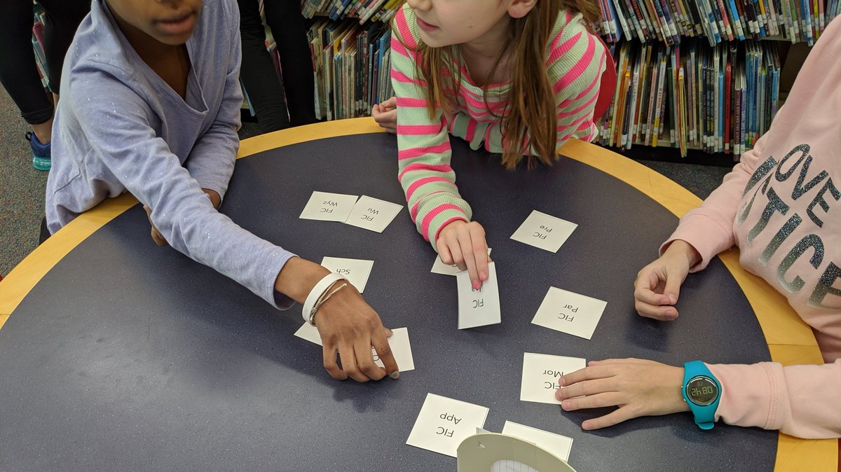 4th graders learning about how fiction is organized in a library