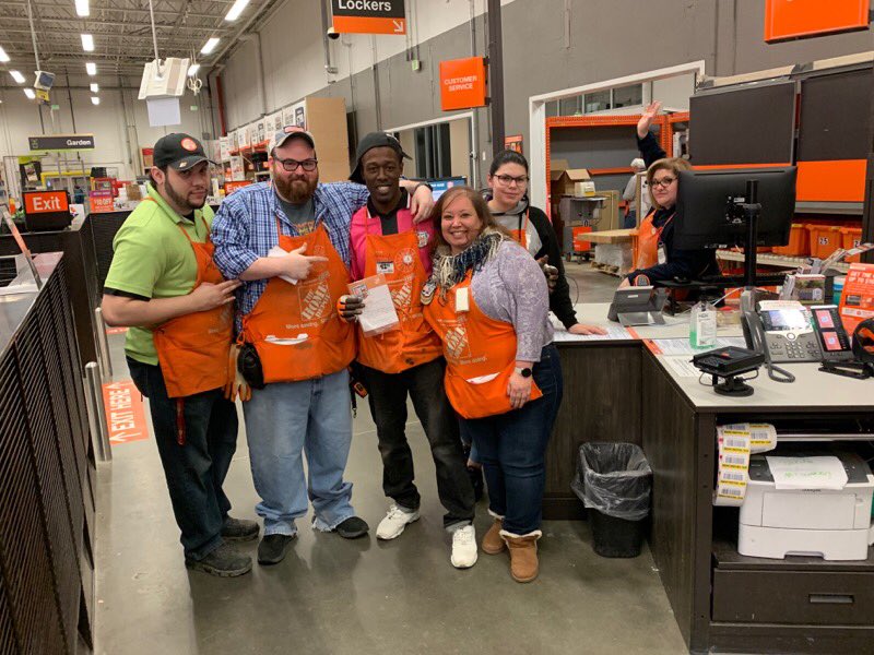 This is Terry, who is receiving a Homer Badge from John DH of Plumbing, for creating shareholder value. Along side Terry and John, is Johnathan, Anna, Alexis, and Jessenia.