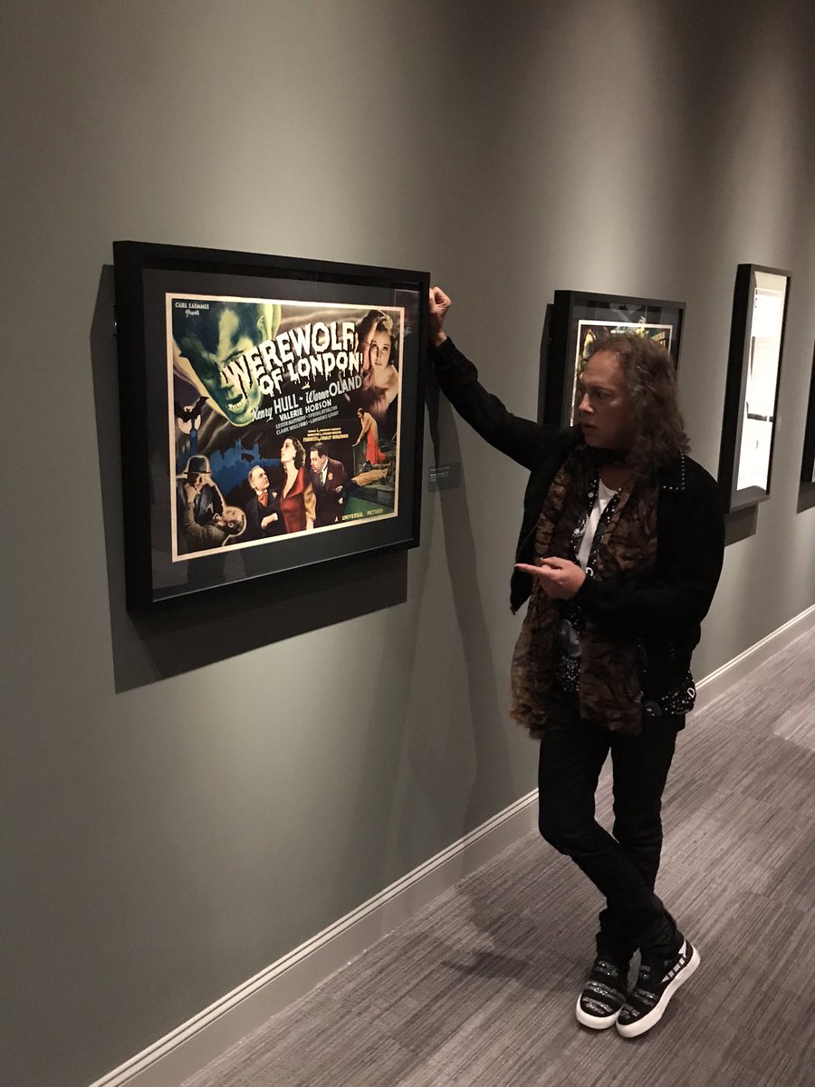 fearfestevil's tweet photo. @KirkHammett gives an impromptu talk about some of his favorite posters on display at the @ColaMuseum #itsalivecma https://t.co/z5W4DJohOE