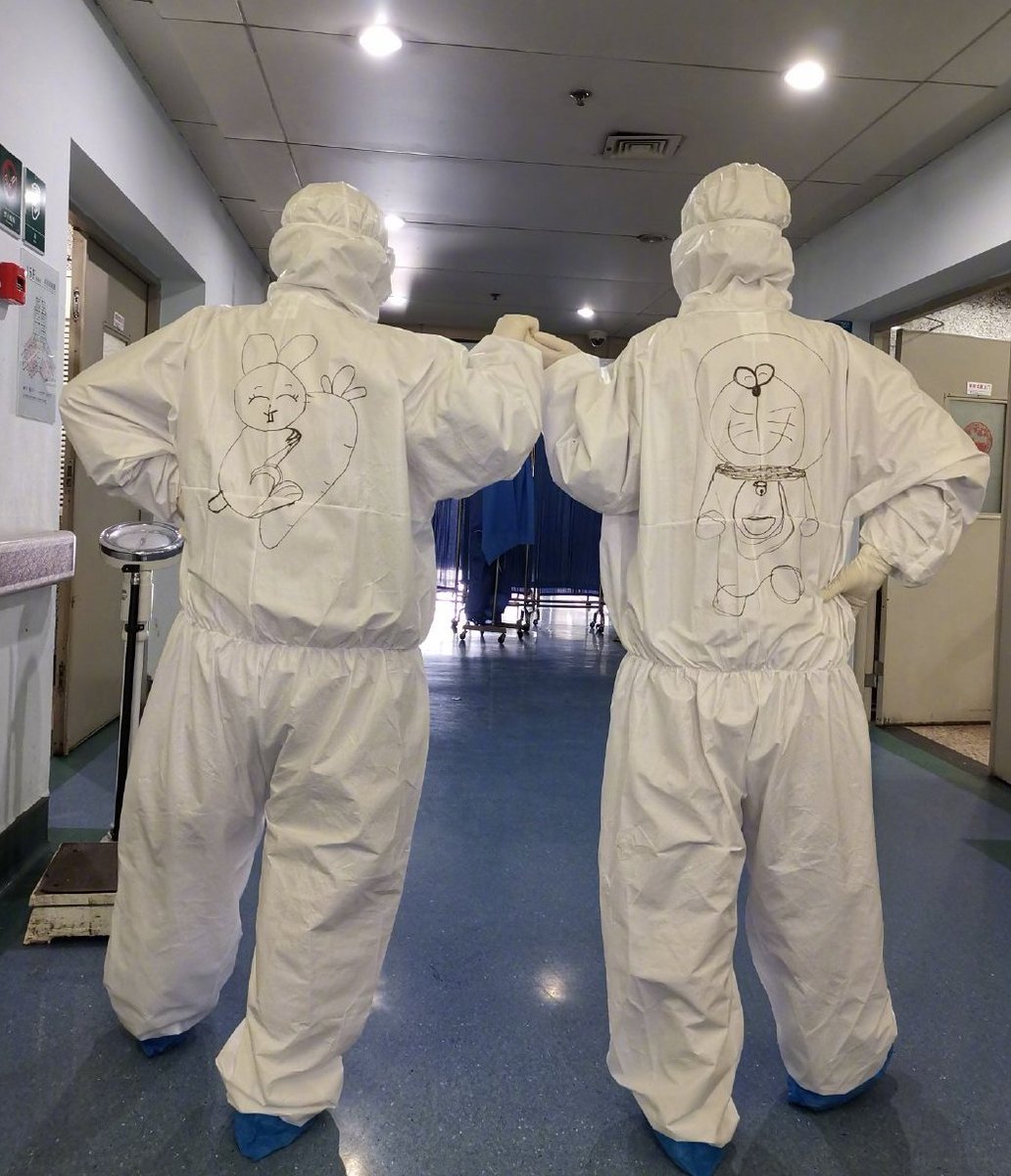 yicaichina's tweet photo. A nurse from Wuhan, the epicenter of the #COVID19 outbreak, has been drawing cartoons on the back of her colleagues’ hazmat suits to ease the tension on the frontlines. Some of her drawings include popular cartoon characters #SailorMoon, #PeppaPig and #Pikachu. https://t.co/B3ZMGn8eQm