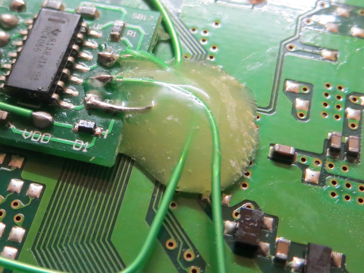 ConsoleMods's tweet photo. Received a non-working #CybdynSystems #PSIO install. What a mess. Glued over wrong wiring, over the board &amp; over bad solder joints. IPA did not break down this glue. Had to use iron to burn it off. Not the prettiest result but now works 100%. #playstation #ps1mods #consolemods https://t.co/FyKkdHp1fN