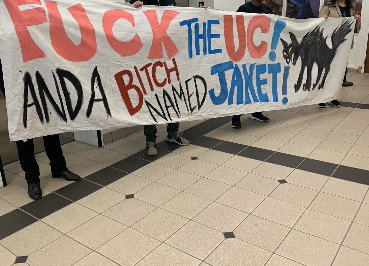 Banner reads: “Fuck the UC! And a bitch named Janet!”