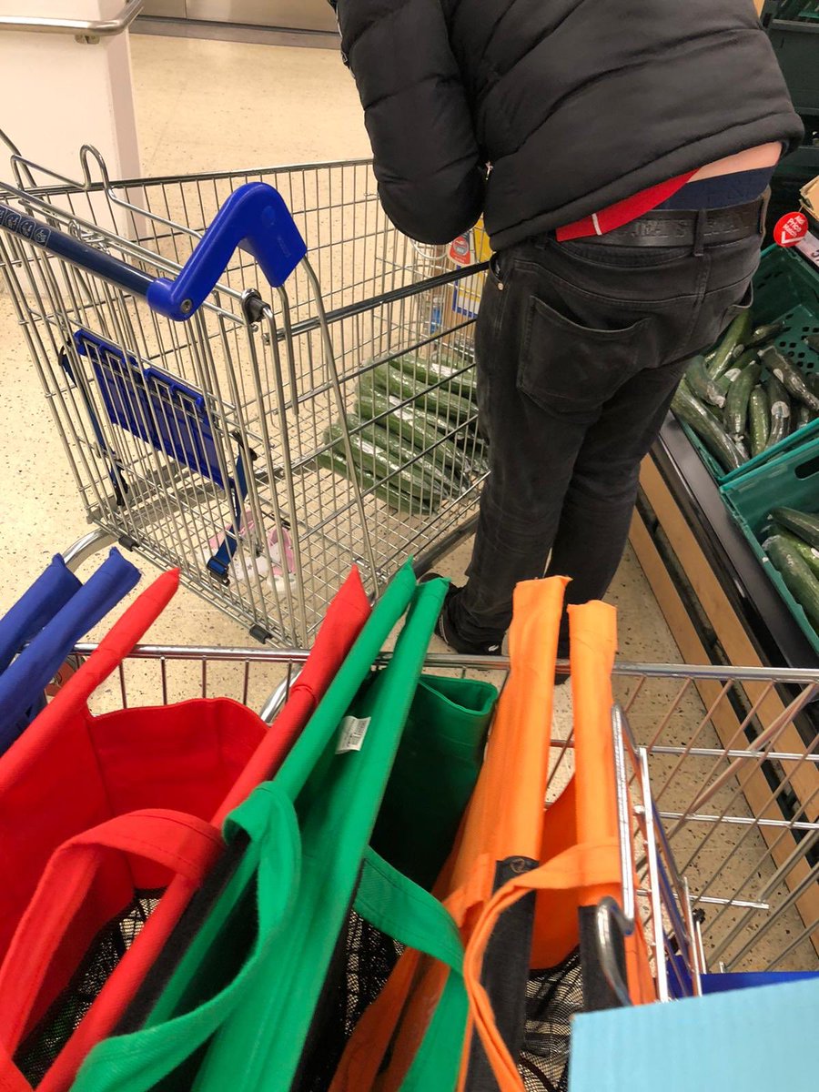 simlamb's tweet photo. People panic buying in Tesco - though not sure this guy’s got it right.  How long can you last on a cucumber only diet? https://t.co/EpgO0MHpyz