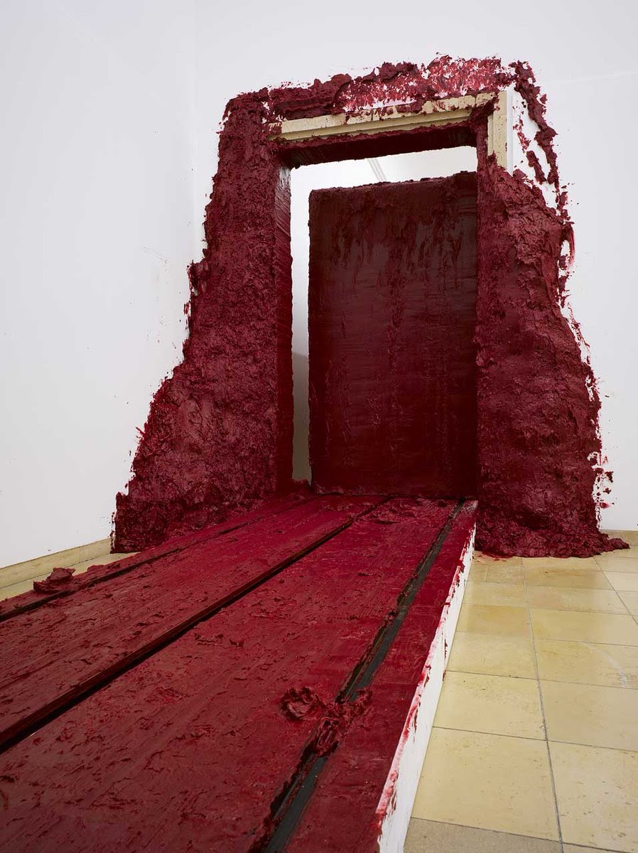 The doors scene in the MV seems to be inspired by an art piece called “Svayambh” (“self-made.”) created by Anish Kapoor. Kapoor who designed the artwork himself along with help from an engineer stated that “It’s as if it’s skinning itself as it goes through the doors.”