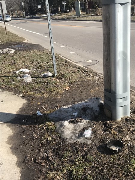 A2Indy's tweet image. AATA bus stop littered with trash. Reported to A2Fixit. City answer: "City of Ann Arbor (Verified Official)
AATA does not provide trash service. They do ask for neighborhood volunteers to adopt bus stops and conduct light maintenance." @CatchTheRide #a2council #garbagepatch