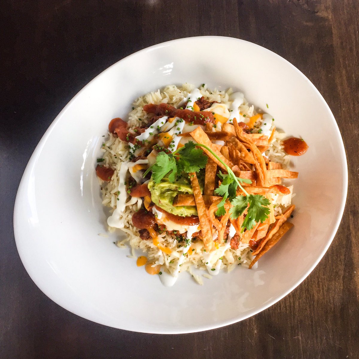 Lunch Special - Chili &amp; Rice Bowl! Beef chili, cumin rice, lime creme, tortilla crisps, guacamole, and cheddar. $15. Lunch 11:30 am - 2:30 pm daily. #lunch #bowl #sandwich #beef #chili #tortillacrisps #Dartmouth #dartmouthcrossing