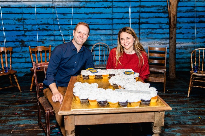 Photo David & Irene Sankoff in front of a number 3 made with cupcakes