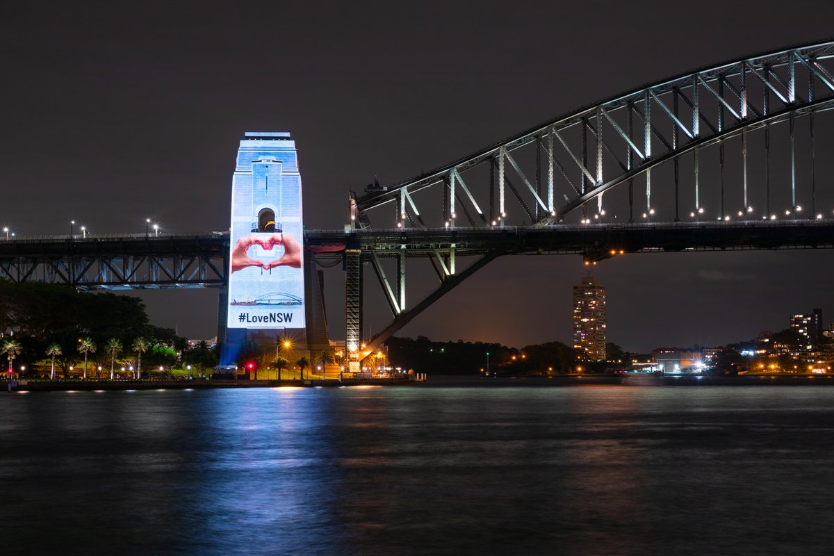 destinationnsw's tweet photo. Last night the southern pylon of the iconic Sydney Harbour Bridge was illuminated with stunning pictures from across New South Wales. From beach to bush, mountains to outback, city to country, it's clear why so many people #LoveNSW! Where are you visiting next? #RecoveryWeekend https://t.co/A8dP3o00zU