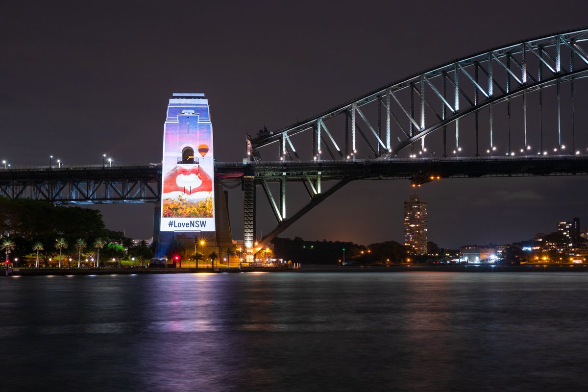 destinationnsw's tweet photo. Last night the southern pylon of the iconic Sydney Harbour Bridge was illuminated with stunning pictures from across New South Wales. From beach to bush, mountains to outback, city to country, it's clear why so many people #LoveNSW! Where are you visiting next? #RecoveryWeekend https://t.co/A8dP3o00zU
