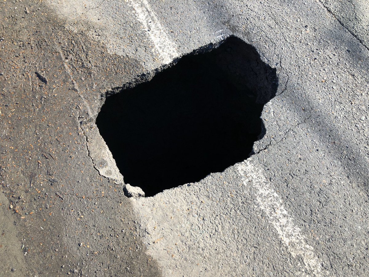 tomayers2262's tweet photo. Small sinkhole opened up by curb on Dominion Street, Reserve Mines. Officials say it’s about 4 metres deep. Appears to be subsidence from old bootleg coal mine, but sewer line is broken, so it could be just a pothole that broke bad. Road blocked, but expected to reopen tonight. https://t.co/g24hutMR1d