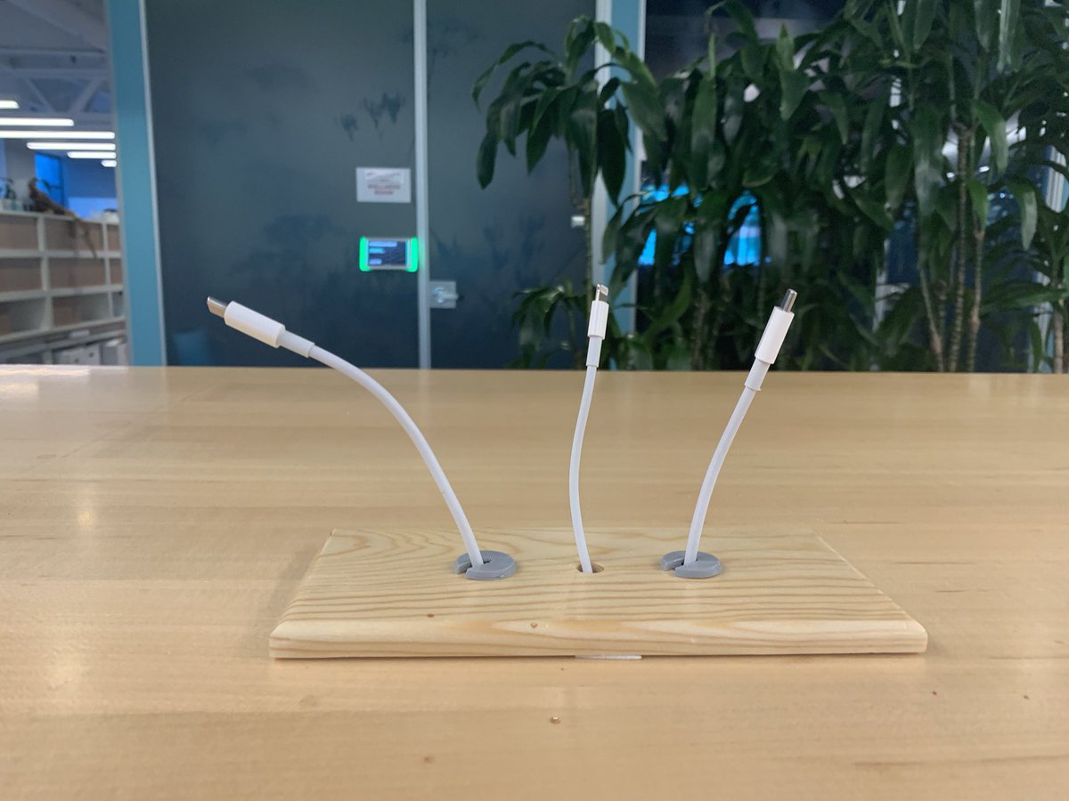 Charging cables poking out of table