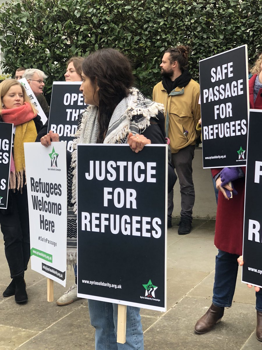 Shaharazad's tweet photo. Crowds are growing in front of @GreeceinUK as campaigners demand justice for #refugees trapped on the islands &amp; at the borders of #Greece. Shame on the #EU - Greece is not a ‘shield’; it’s a brutal prison. #safepassage #refugeeswelcome https://t.co/Q1kVGwWhy7