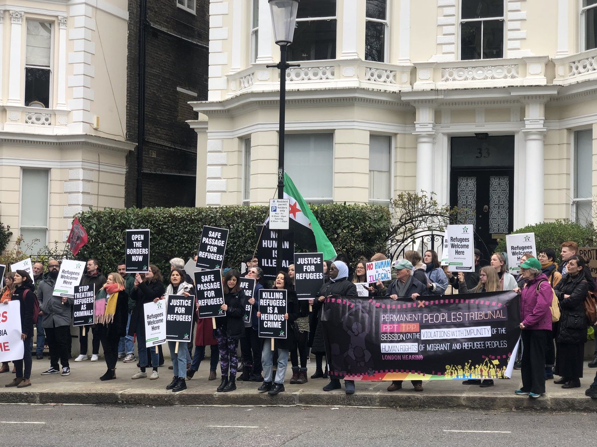 Shaharazad's tweet photo. Crowds are growing in front of @GreeceinUK as campaigners demand justice for #refugees trapped on the islands &amp; at the borders of #Greece. Shame on the #EU - Greece is not a ‘shield’; it’s a brutal prison. #safepassage #refugeeswelcome https://t.co/Q1kVGwWhy7
