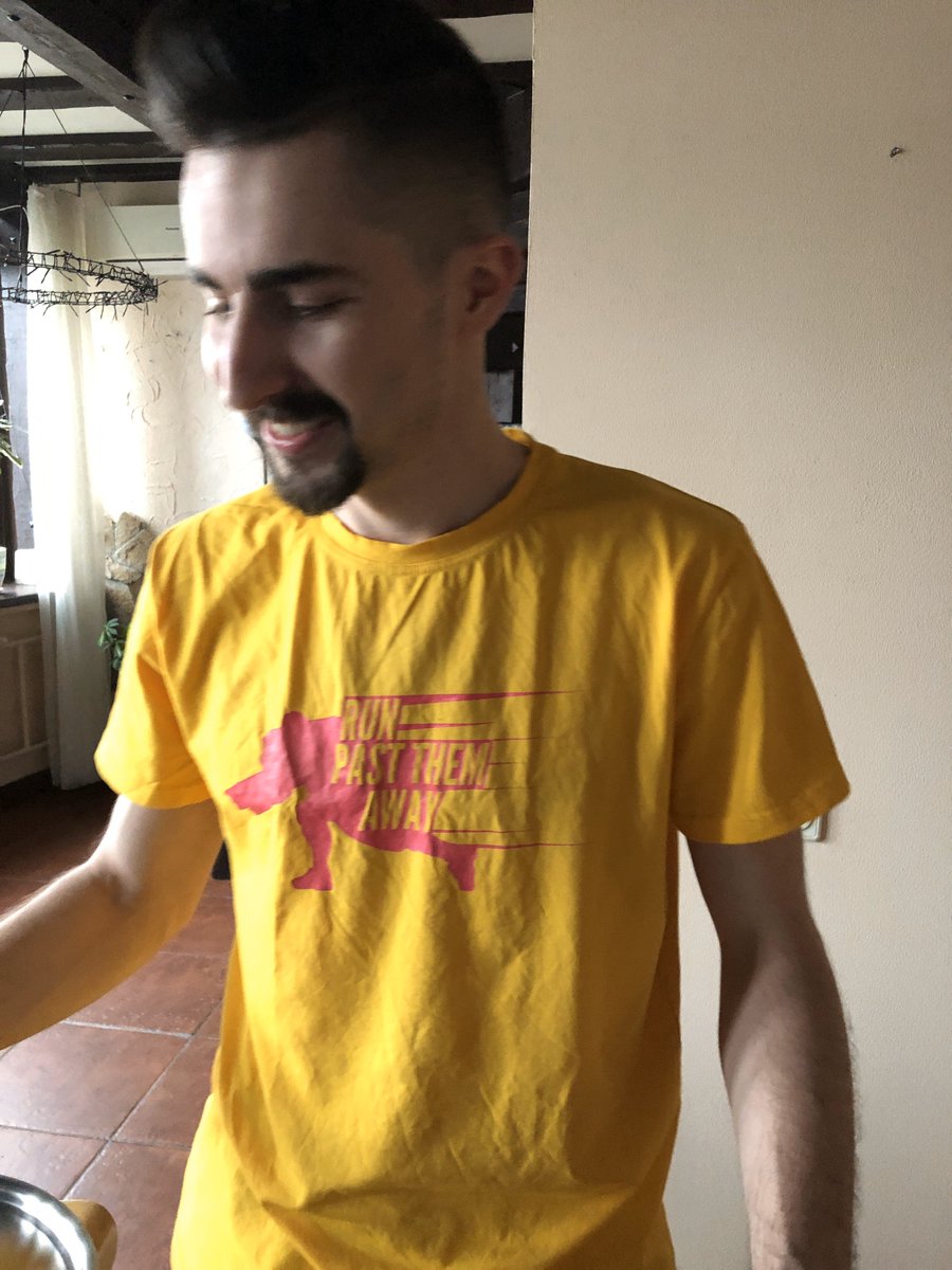 man wearing yellow tshirt with RUNPASTTHEMAWAY logo on it