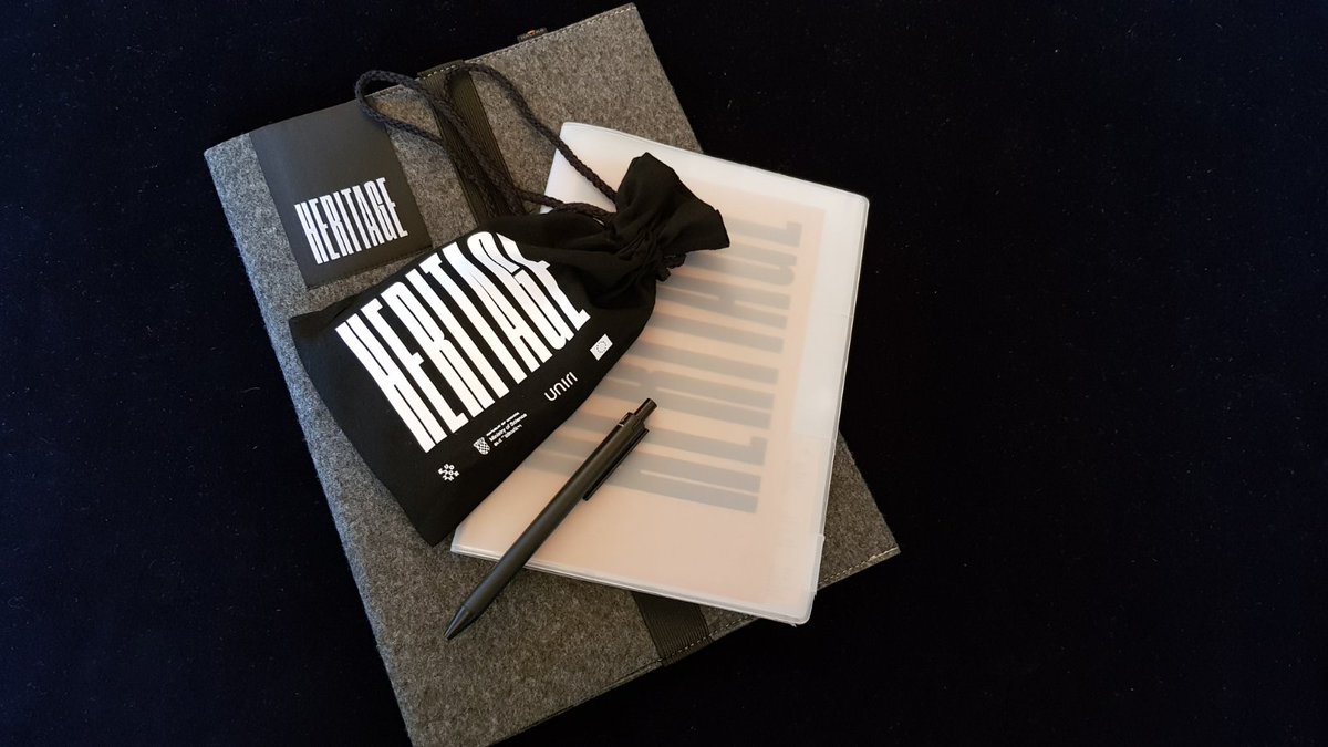 2020_heritage's tweet photo. One cool conference package: a notebook made of recycled paper, a practical „purse“ (don't worry, looks good on men, too!), a pen. 
But the coolest thing is in the little black bag: a mind teaser made of wood! If you solve it, please do brag online: post a picture and tag us! https://t.co/qXU1BKl2K9