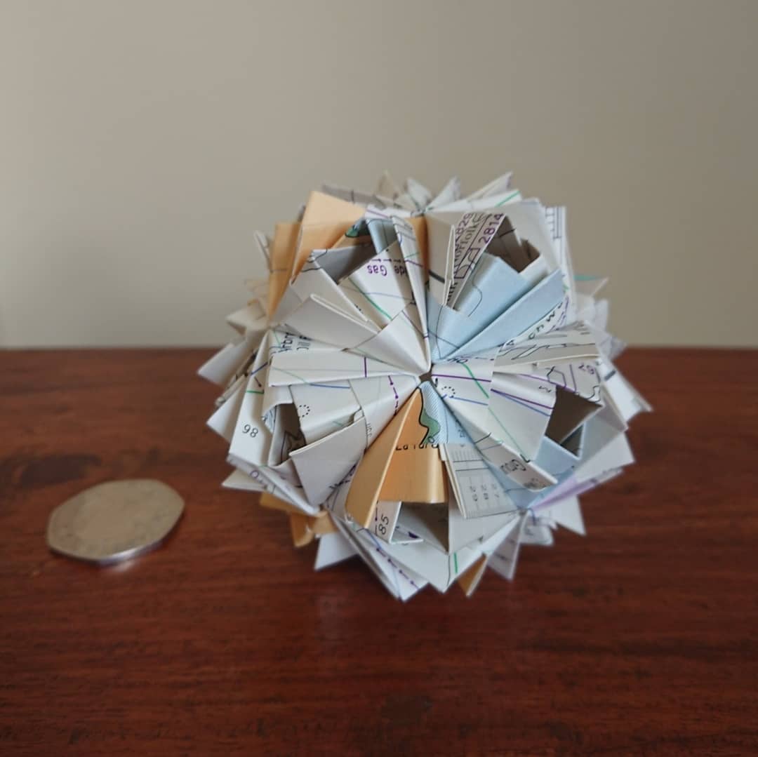 MattBookbinding's tweet photo. Etna Kusudama (Maria Sinayskaya). Folded by me from a nautical chart (from a notebook made of recycled admiralty charts). 30 x rectangular units using no glue. #origami #modularorigami #etna #nauticalchart #nauticalmap #navigation #sea #ocean #recycle #recycledcrafts https://t.co/WbsfEV6EYn