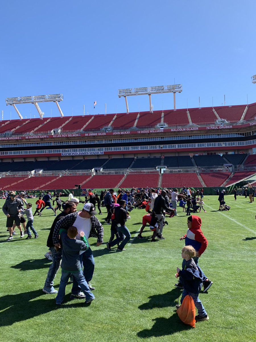 Dads being Dadswith their kids at the AllPro Dads ”Tickle Tackle” at Raymond James Stadium
