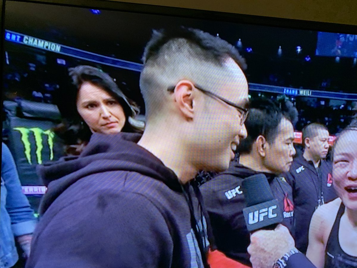 MaxBlumenthal's tweet photo. After defending her title in epic fashion, China’s Zhang Weili uses the opportunity to call for global cooperation and unity against #coronavirus. Yes, that’s @TulsiGabbard behind her. #UFC248 https://t.co/QdPkW4NzRi