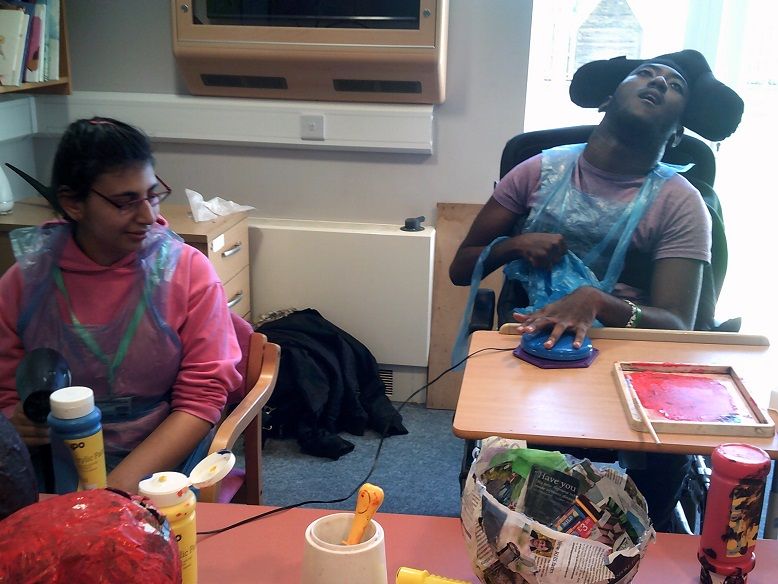HenshawsCollege's tweet photo. Check out two of our College students showing amazing #teamwork to dry some papier mache in one of our #enterprise sessions. Seb is activating the switch for Mounika to use a hairdryer to help dry the work they have been doing. Super effort guys! #Henshaws #BuildingConfidence https://t.co/d1VbLvMuuC