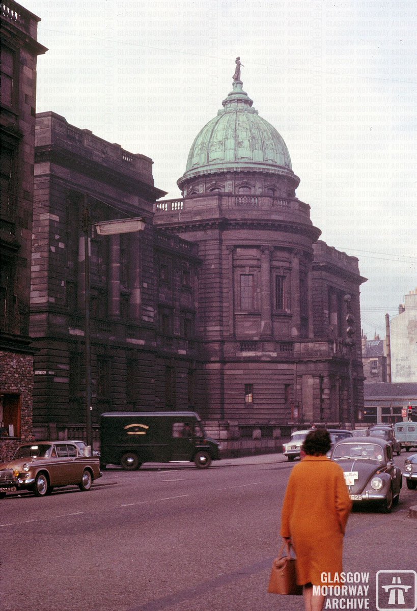 A #Glasgow #streetscene to take us even further back in time - this shot shows @GlasgowLib #MitchellLibrary in North St in Oct '64. Some stark contrast between the dirty elevations, the elegant lady on her way to Charing X and the golden Sunbeam Rapier parked across the road! ^WB