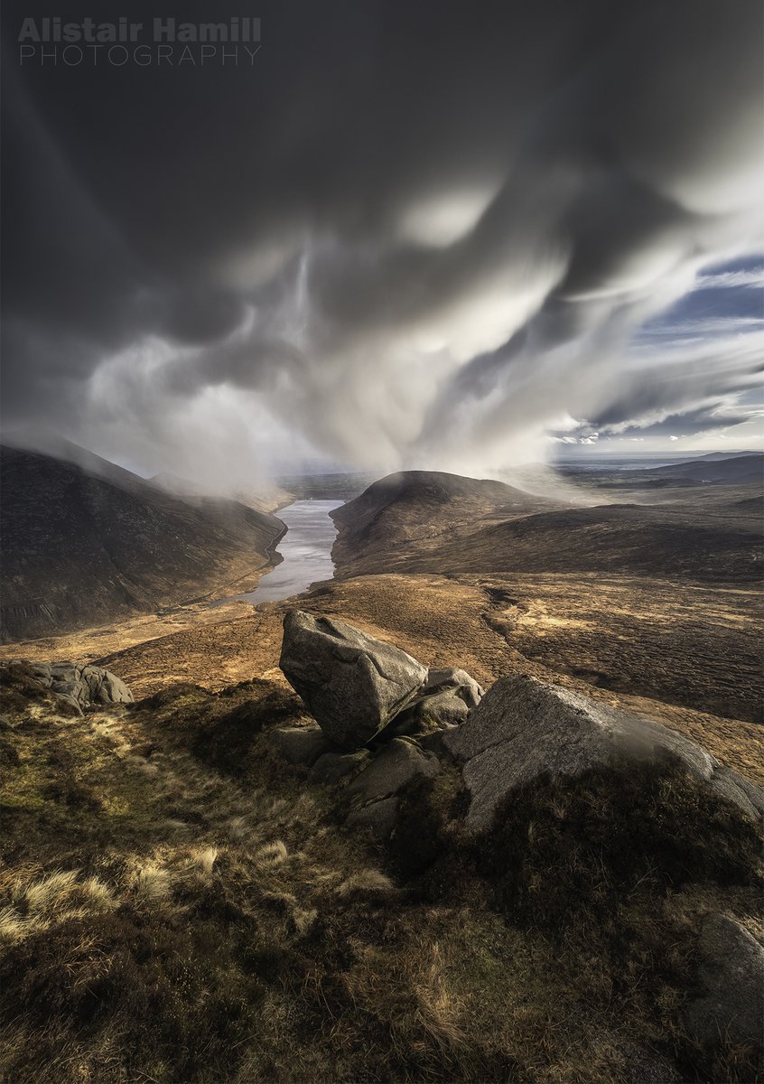 ahamillphotos's tweet photo. I may have had to shelter by a rock for 15 minutes whilst a hail storm passed today. But it was worth every stinging hit on the face to be greeted by this view as the shower cleared over Binnian. Mammatus clouds: the most dramatic scene I've ever witnessed up the Mournes! https://t.co/xwkseFqnir