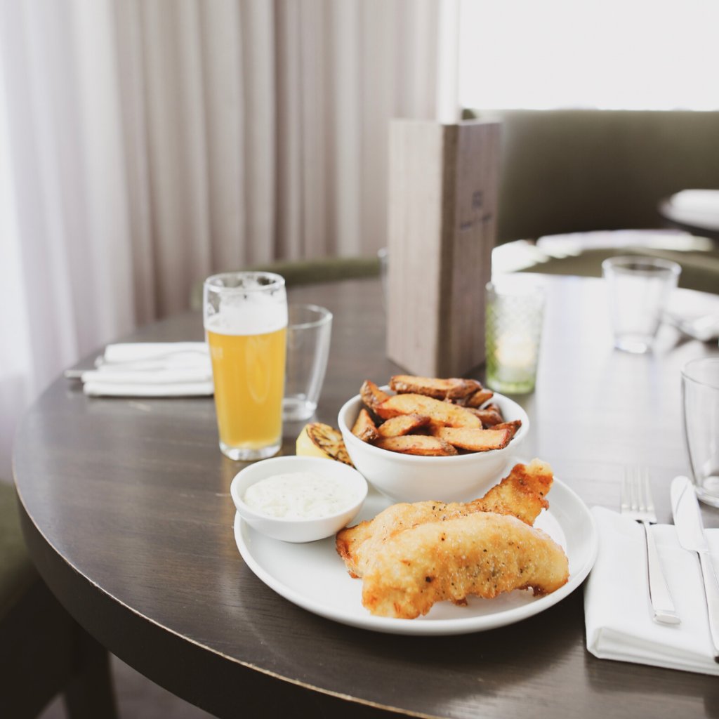 Fish and Chips made with a shandy, @oceanwiselife Lake Erie pickerel, chips, tartar sauce, and a charred lemon. spr.ly/60191o3jz