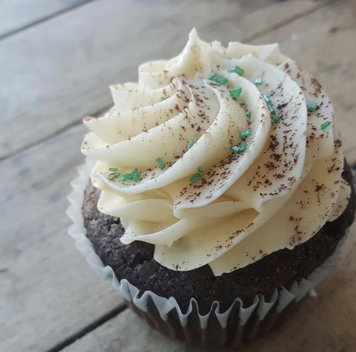Get ready to put your green on! We're prepping for St. Patrick's Day by having our Guinness &amp; Bailey's cupcake starting this week 🍀 Check out the daily Facebook post for flavors each day! [Chocolate Guinness cake topped with Bailey's Irish Cream buttercream &amp; a dusting of cocoa]