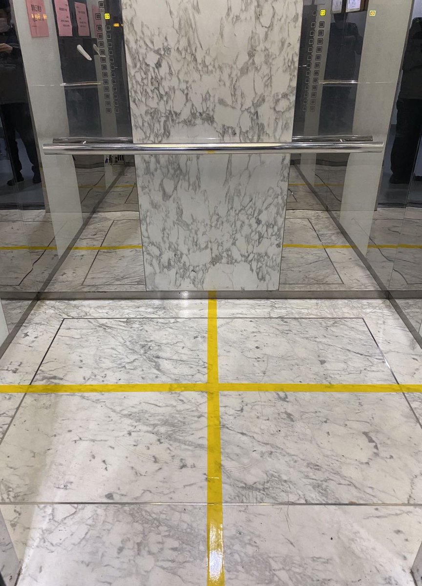 The Chinese government is slowly beginning to lift restrictions, but it is continuing to implement many quite inventive procedures, on a large scale. For instance, elevators in a Beijing building only allow four people at a time, as marked by tape on the floor. 15/