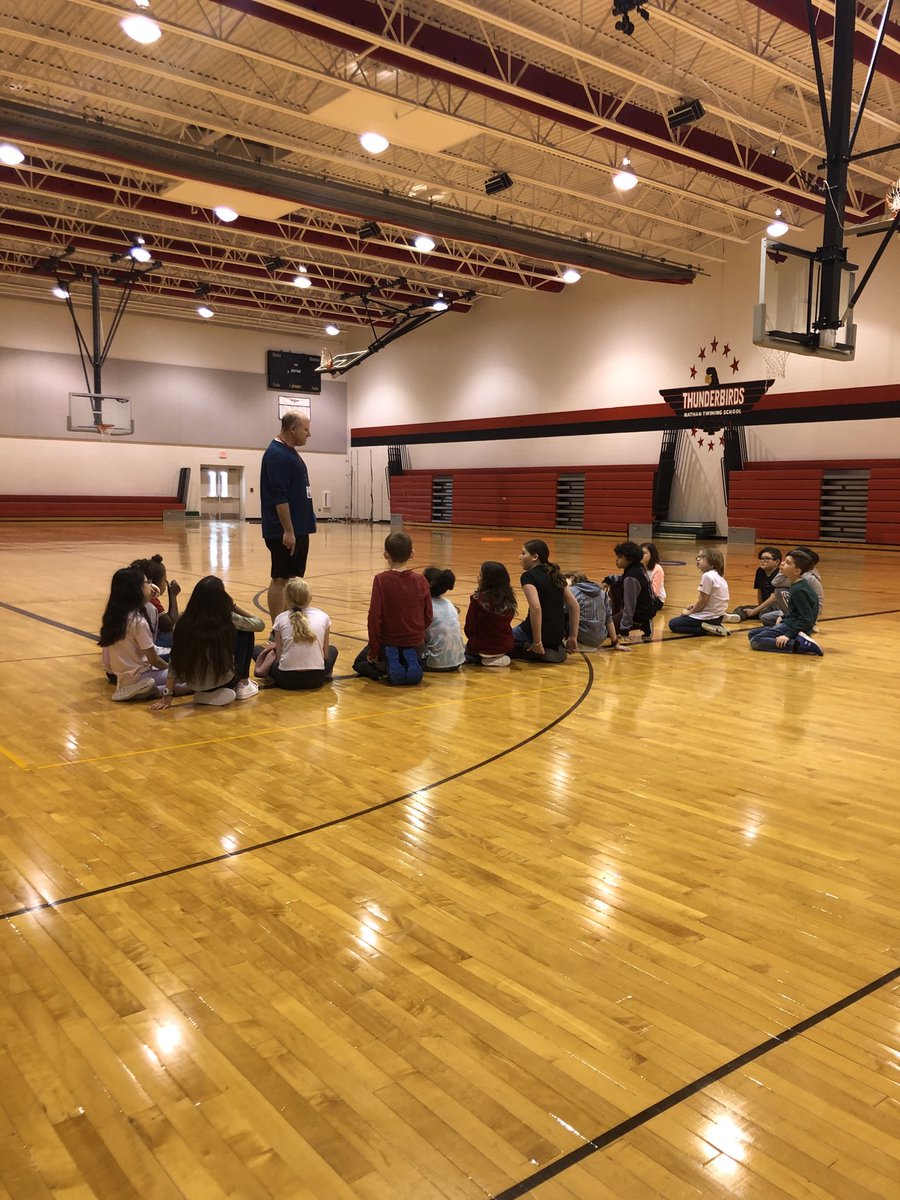 Mr. Fore teaching the fundamentals of Four Square to the fourth graders