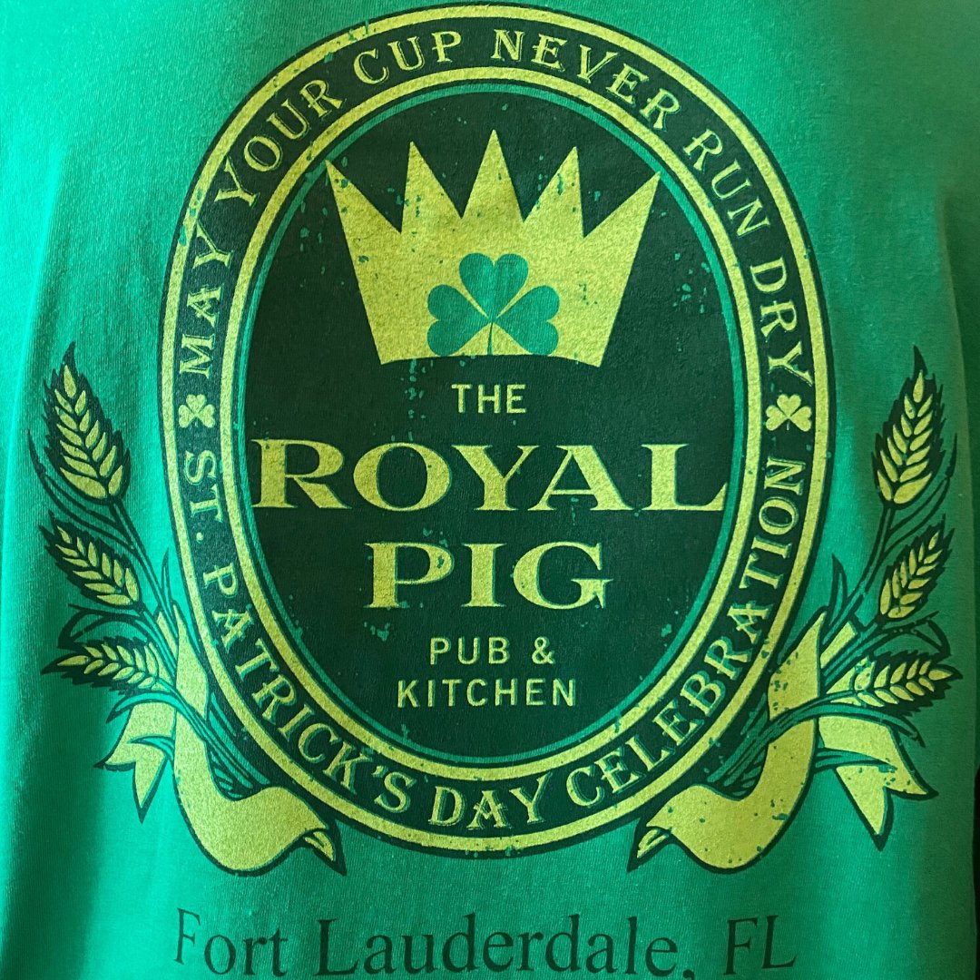 RoyalPigPub's tweet photo. ☘️ #StPaddysDay tees are now on sale for $16 + tax! Stop by tonight for our Monday $10 burger, beer and fry night and get one before they're gone! Lmited reserved space available for the St. Patrick's Day Parade: Email: events@royalpigpub.com. $15/seat or call 954-617-7447. https://t.co/VGCyXAPGJ4