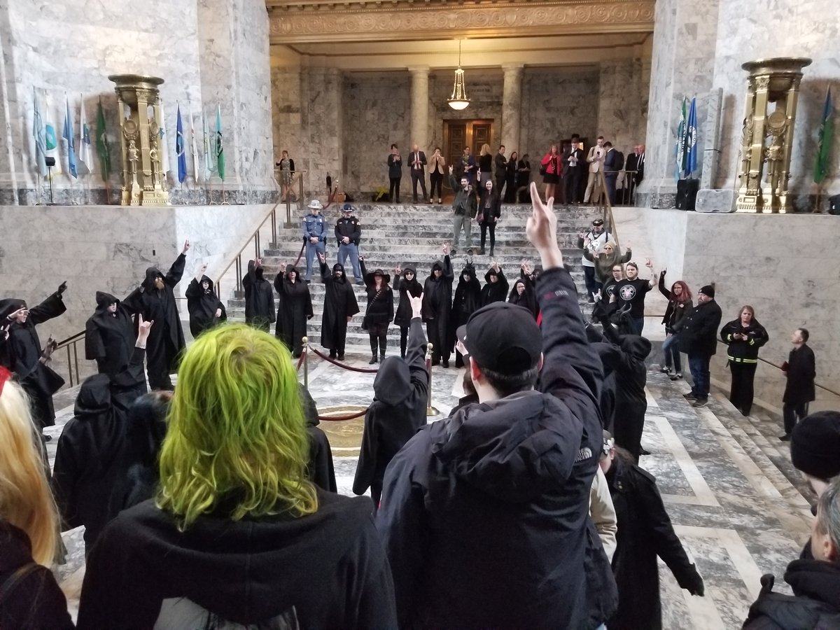 TST_Washington's tweet image. Scenes from the Satanic Invocation at Washington State Capitol

Christian nationalists arrived in protest &amp;amp; attempted to invoke the name of their god against the chapter's beautiful expression of religious freedom, but they were powerless to stop our unholy rites

Hail Satan
^ADJ