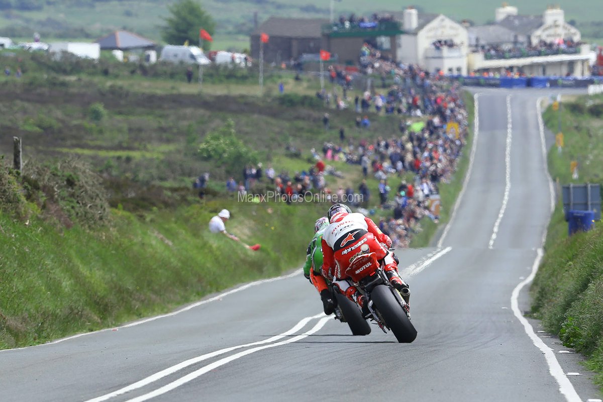 John McGuinness slides out of Kate's Cottage breathing down the neck of James Hillier in the 2014 Senior TT race