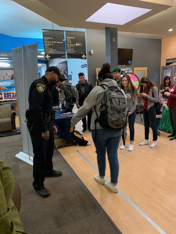 PCCPD's tweet photo. Officers Serna and Kron offering some spring break safety tips to students at PCC Desert Vista Campus. The DUI goggles were very effective in showing the dangers of being under the influence. #KnowYourLimits #SpringBreak20 https://t.co/7p3Xl7t3bR