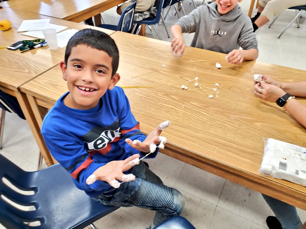 Here, the students are tapping into their creative sides to create structures with uncooked spaghetti pasta and marshmallows!