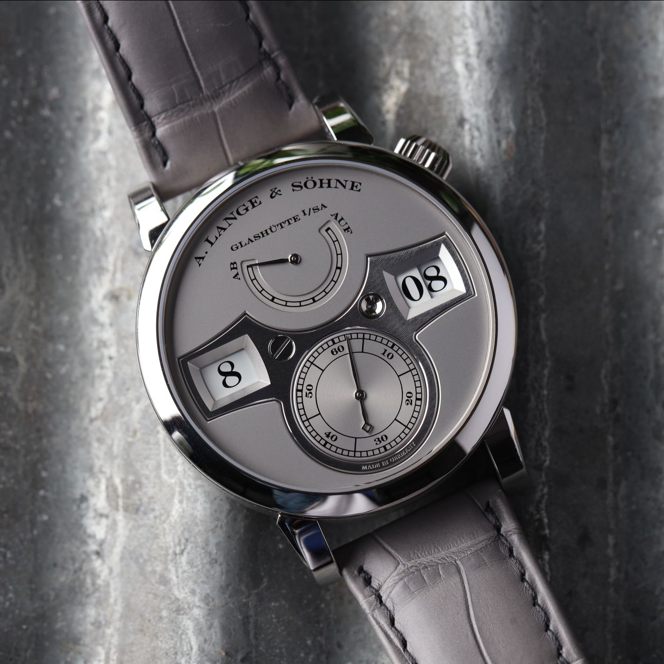 The 1916 Company WatchBox on X All grey tones were used on this exceptional A. Lange Sohne Zeitwerk Limited Edition reference 140.025. The timepiece has a 41.9mm platinum case silver dial