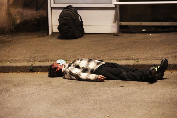 garywilson2013's tweet photo. A disturbing image of a man wearing a protective mask lying unconscious near a bus stop in Italy before being helped by medical personnel In Italy. #coronavirusuk #uknext https://t.co/UrQUEAibzU
