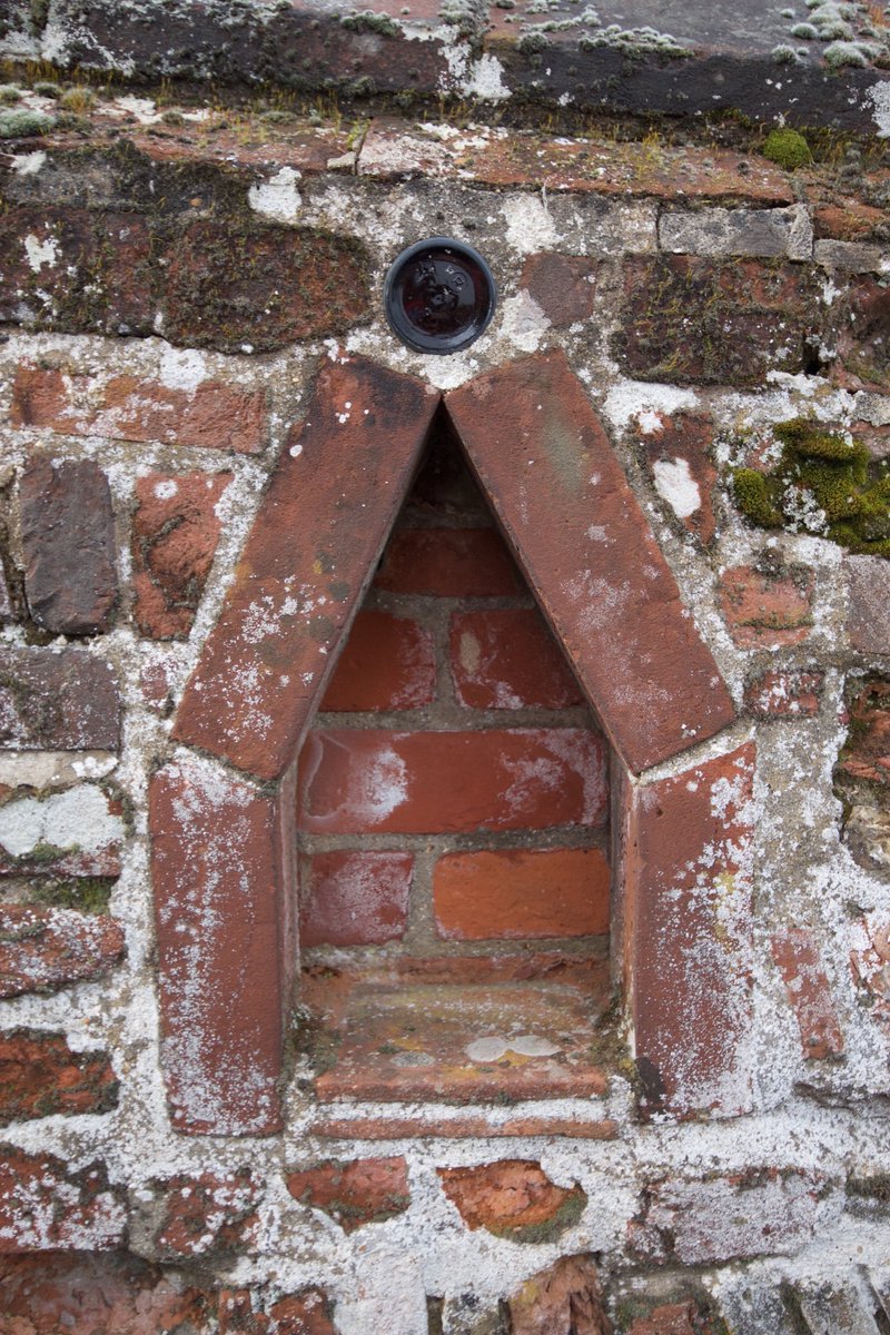 Archaeology twitter - what are these niches seen in garden walls in Lavenham, Suffolk. Always this form and size, five bricks and a beer bottle?